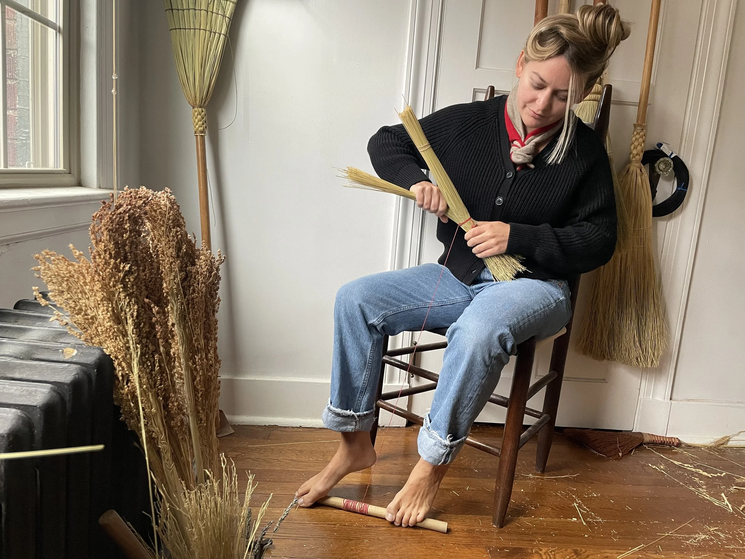 Local artist handcrafting functional brooms for cottage fireplaces natural spaces traditional craft