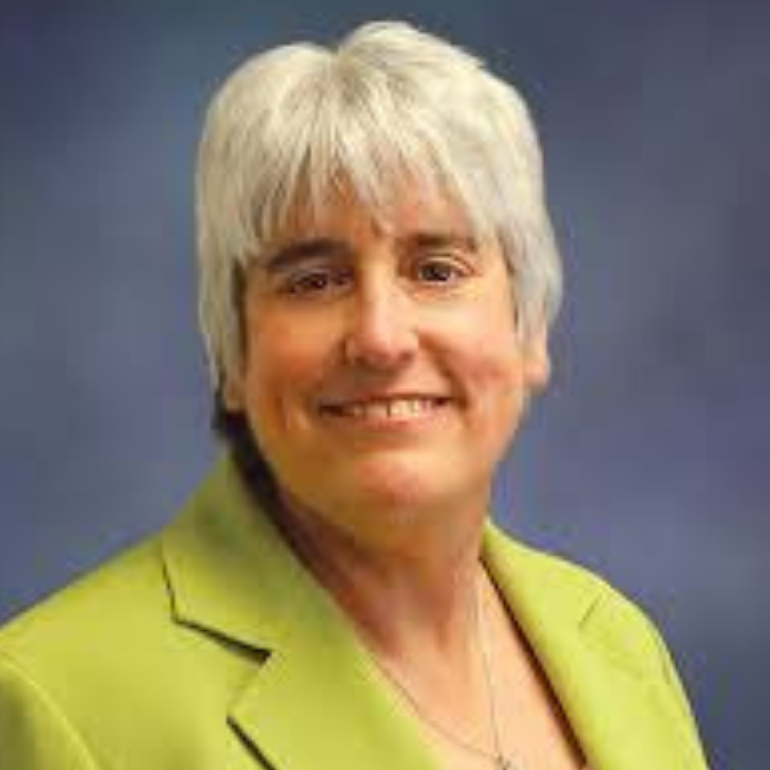 woman smiling, featured in testimonial about The Greater Sum Foundation program