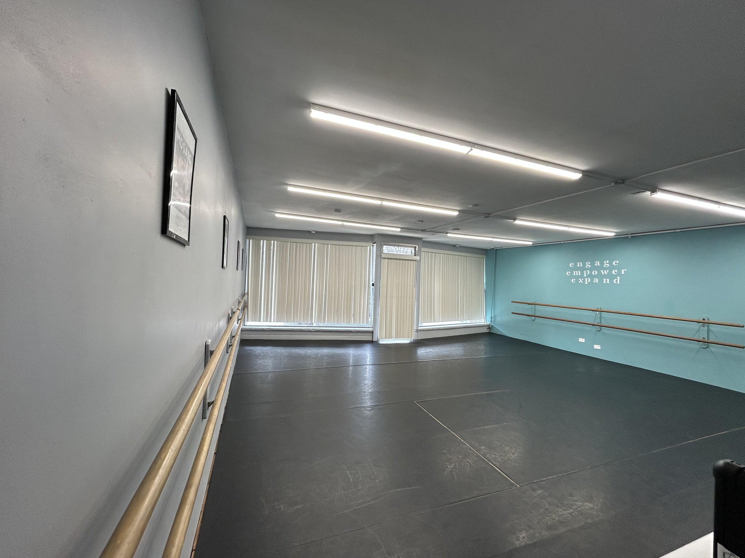 625 sq ft (25’x25’) | black marley floors | two wall of barres | one wall of large windows and natural light | stereo system |