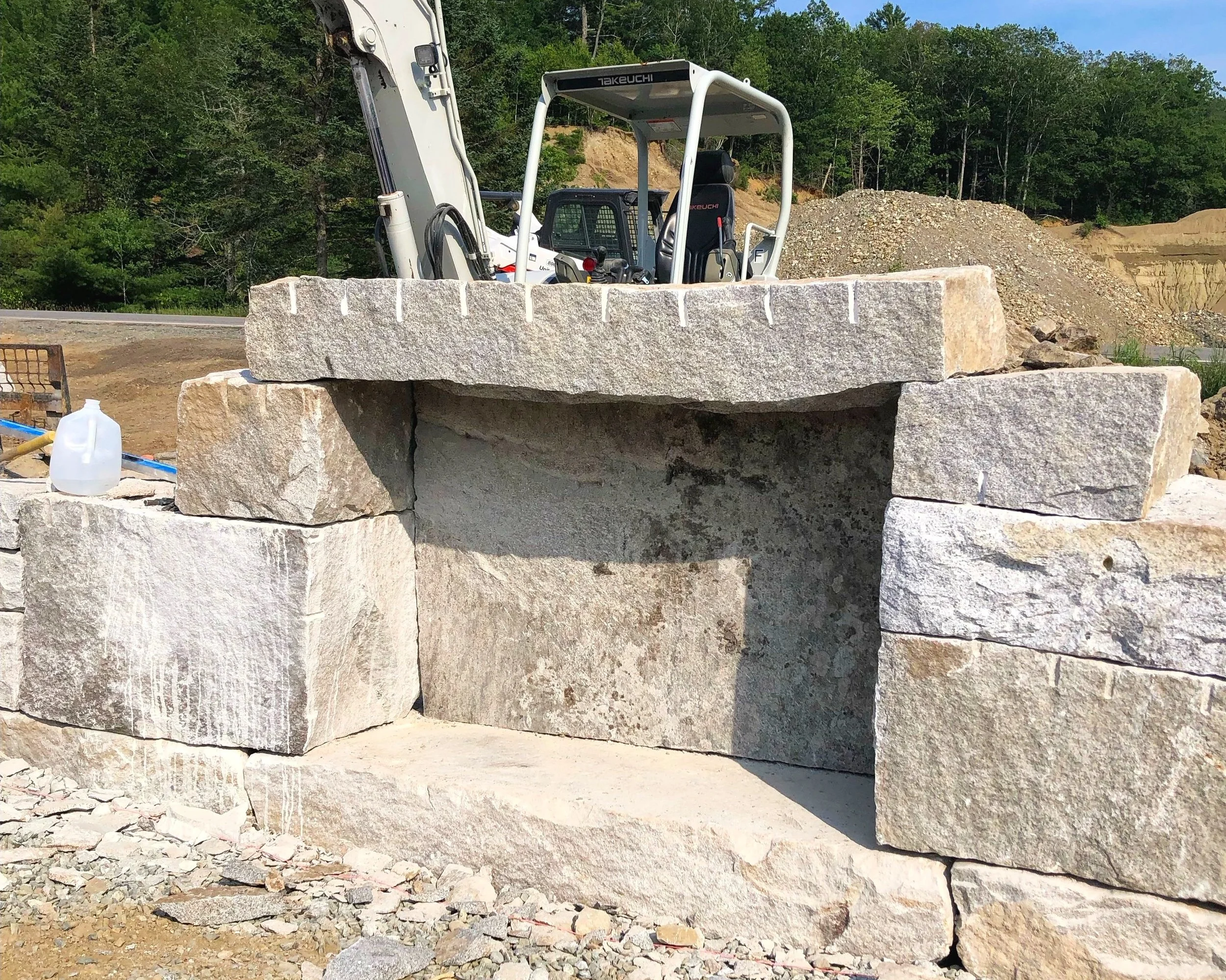 Dry granite wood storage feature with Maine Stonescapes for Mathew Cunningham Landscape Architect. Bucksport, ME