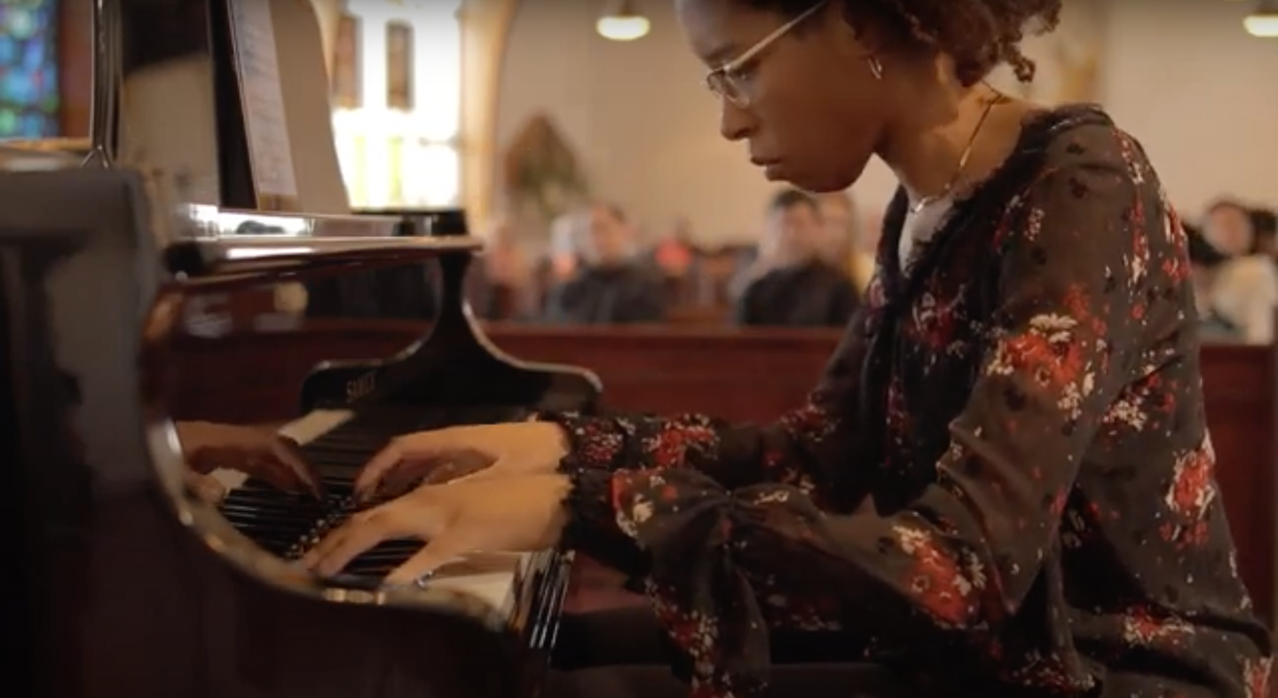 Person playing the piano in a church setting