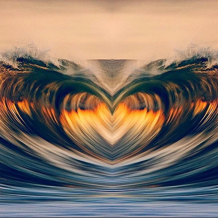 Symmetrical image of ocean waves forming a heart shape at sunset