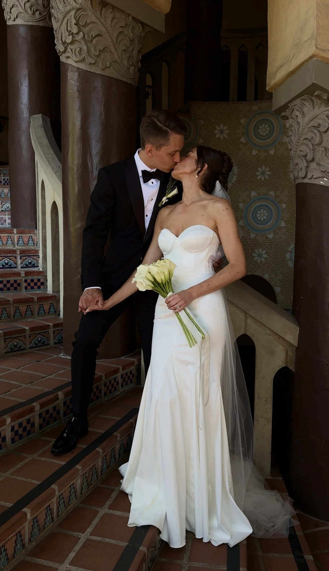 Woman wearing a lace veil and white wedding gown