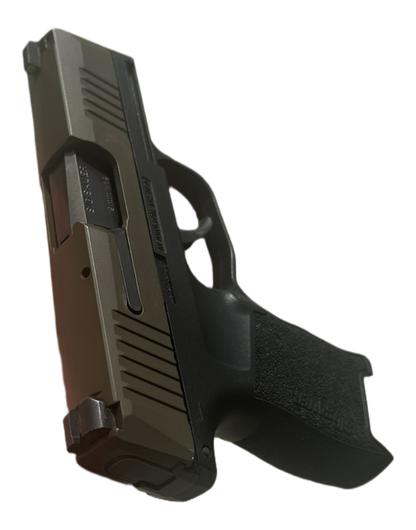 Close-up of a semi-automatic pistol with a black grip, metallic slide, and textured handle.