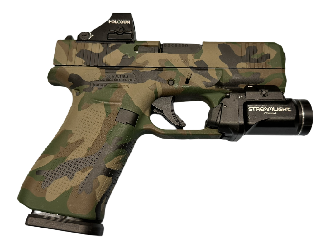 A camouflage-patterned handgun with a mounted flashlight.