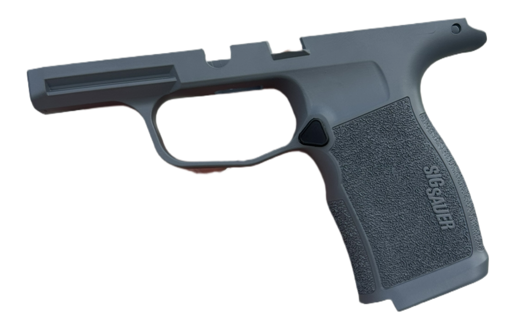 A disassembled gray polymer handgun frame with a textured grip and a trigger guard.