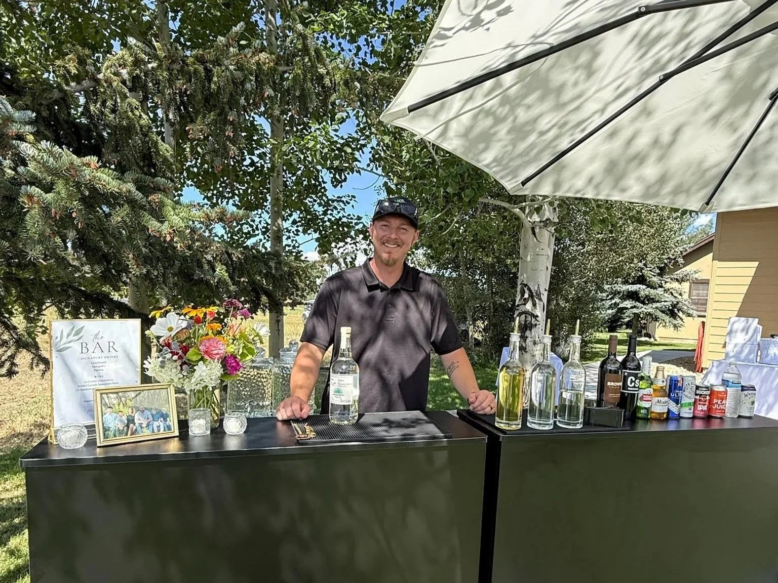 Bartender at a mobile bar with umbrella for wedding reception