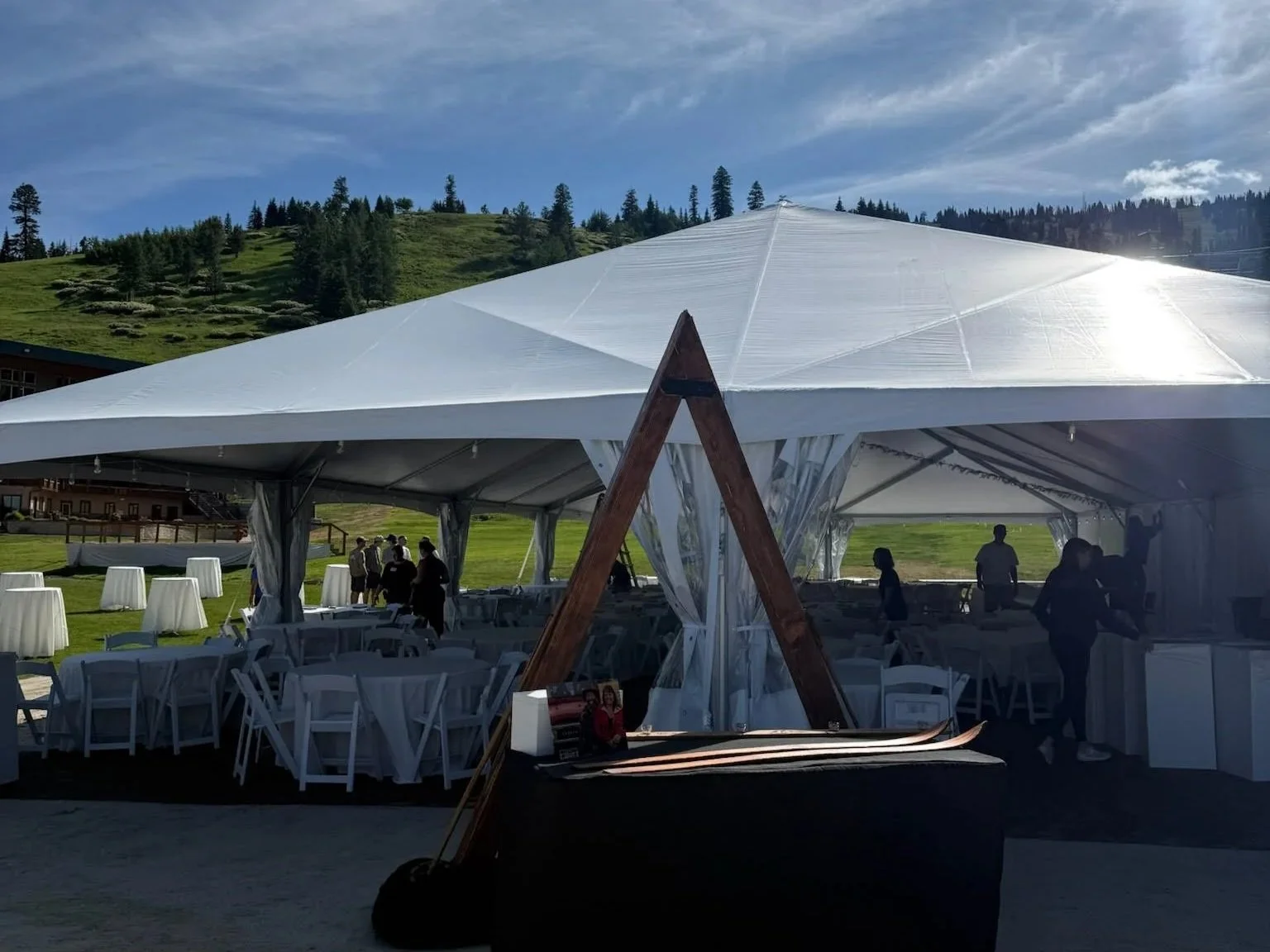 Exterior of an event with large event tent and wedding arch