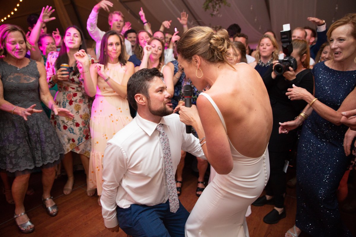 Bride singing to her groom on the dance floor as they dance and get funky. She was giving a rousing rendition of "shoop" by Salt n Peppa.