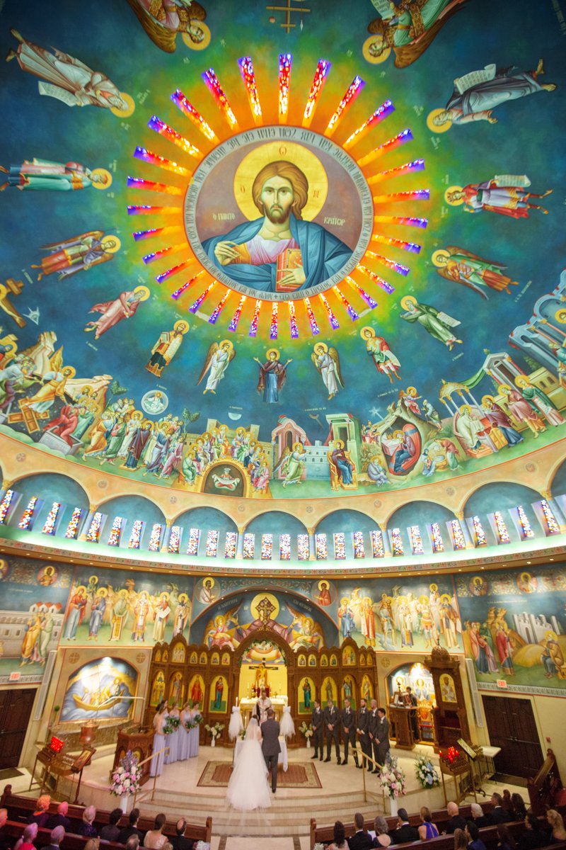Classic Greek Orthodox ceremony showing off the incredible artwork and domed ceiling of the church.