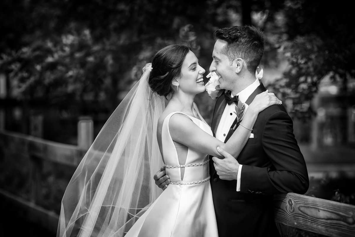 Black and white of a couple joyously embracing.