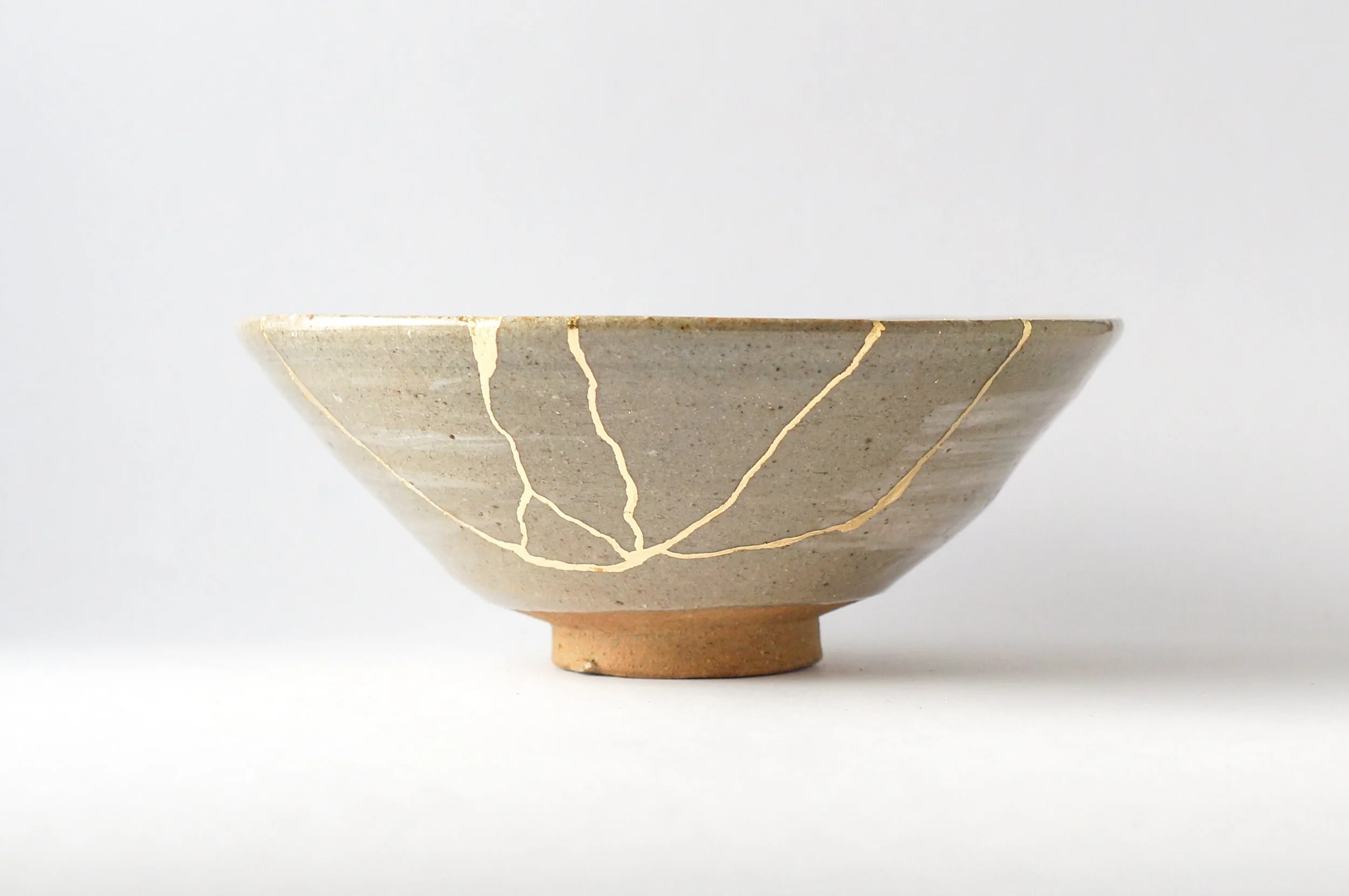 Kintsugi gold-repaired pottery symbolizing healing and wholeness
