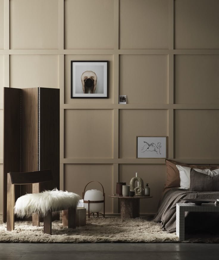 A modern, minimalist bedroom with beige paneled walls.