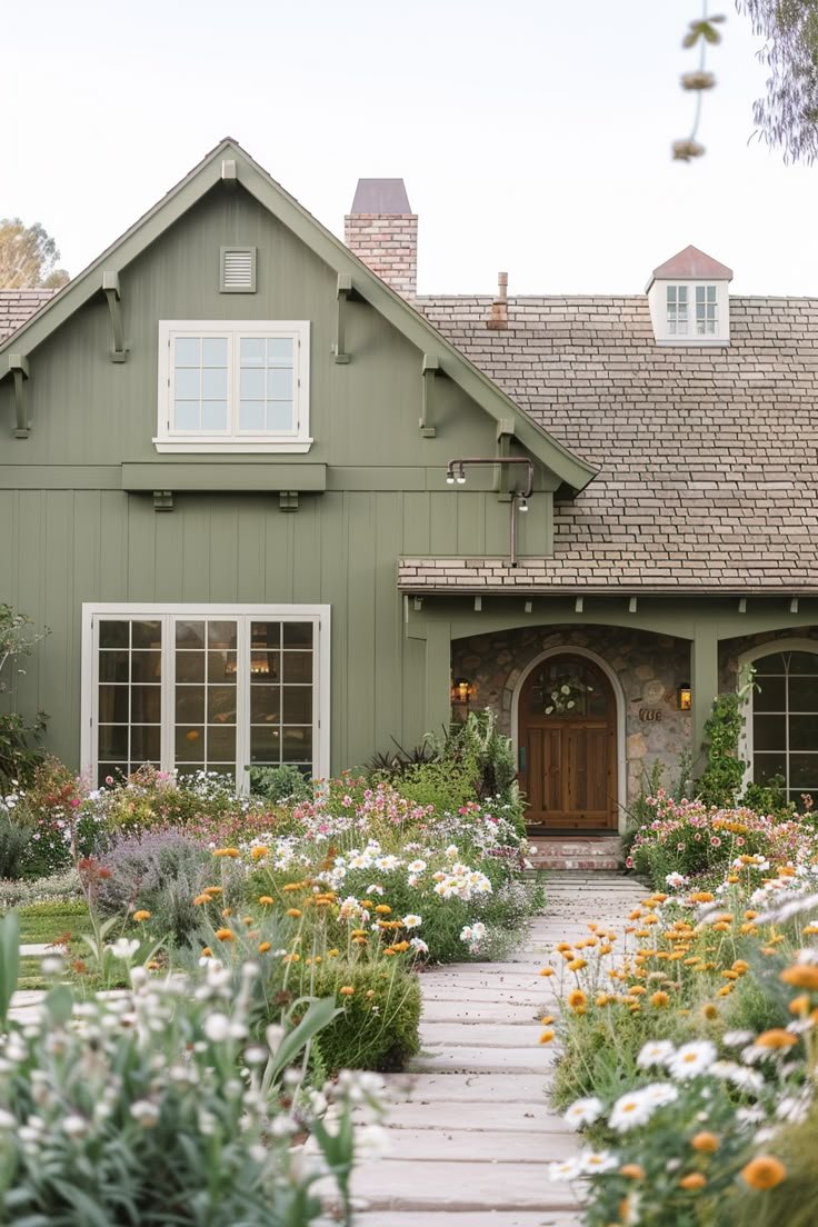 Charming green house with garden path and colorful flowers