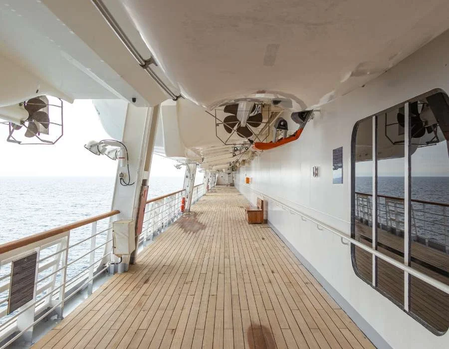 Empty deck on a cruise ship with windows viewing the ocean.