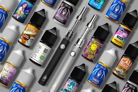Collection of vaping devices and e-liquid bottles on a surface.