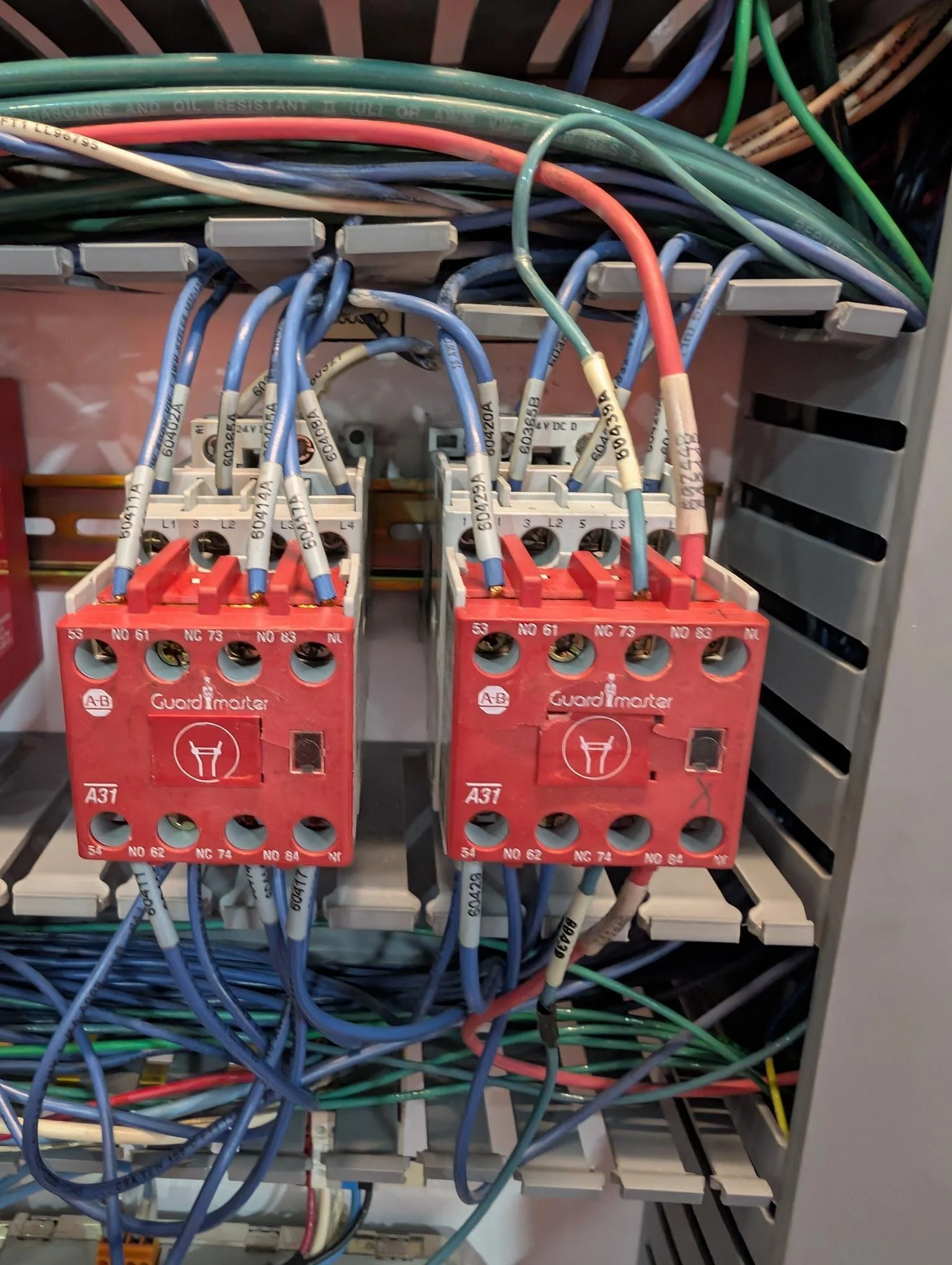 Close-up of an electrical control panel with circuit relays and wiring.