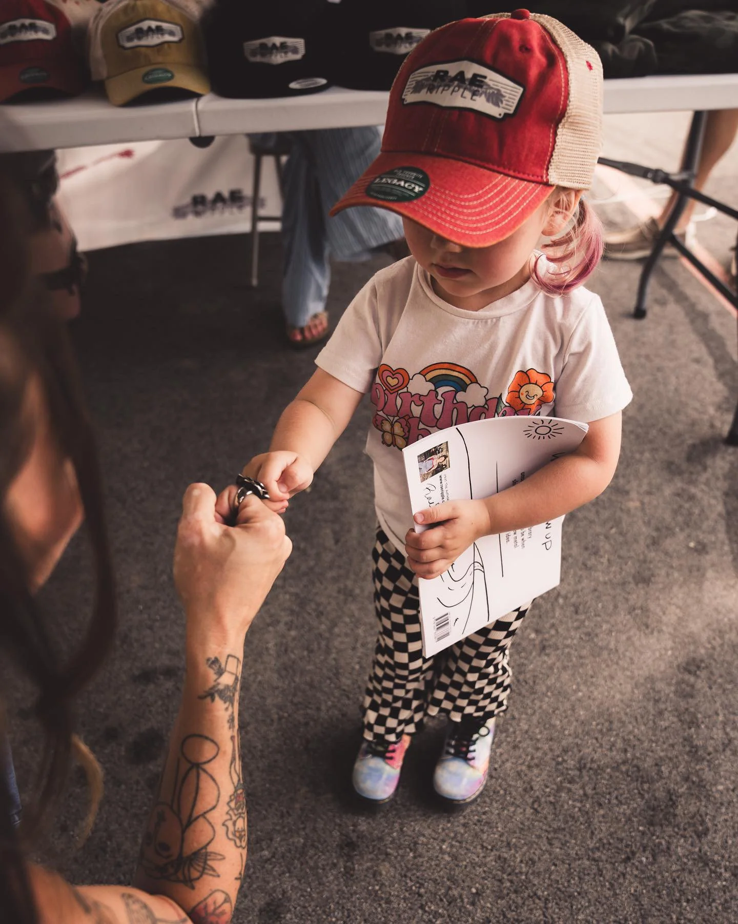 Rae Ripple connecting with a young visitor at an event