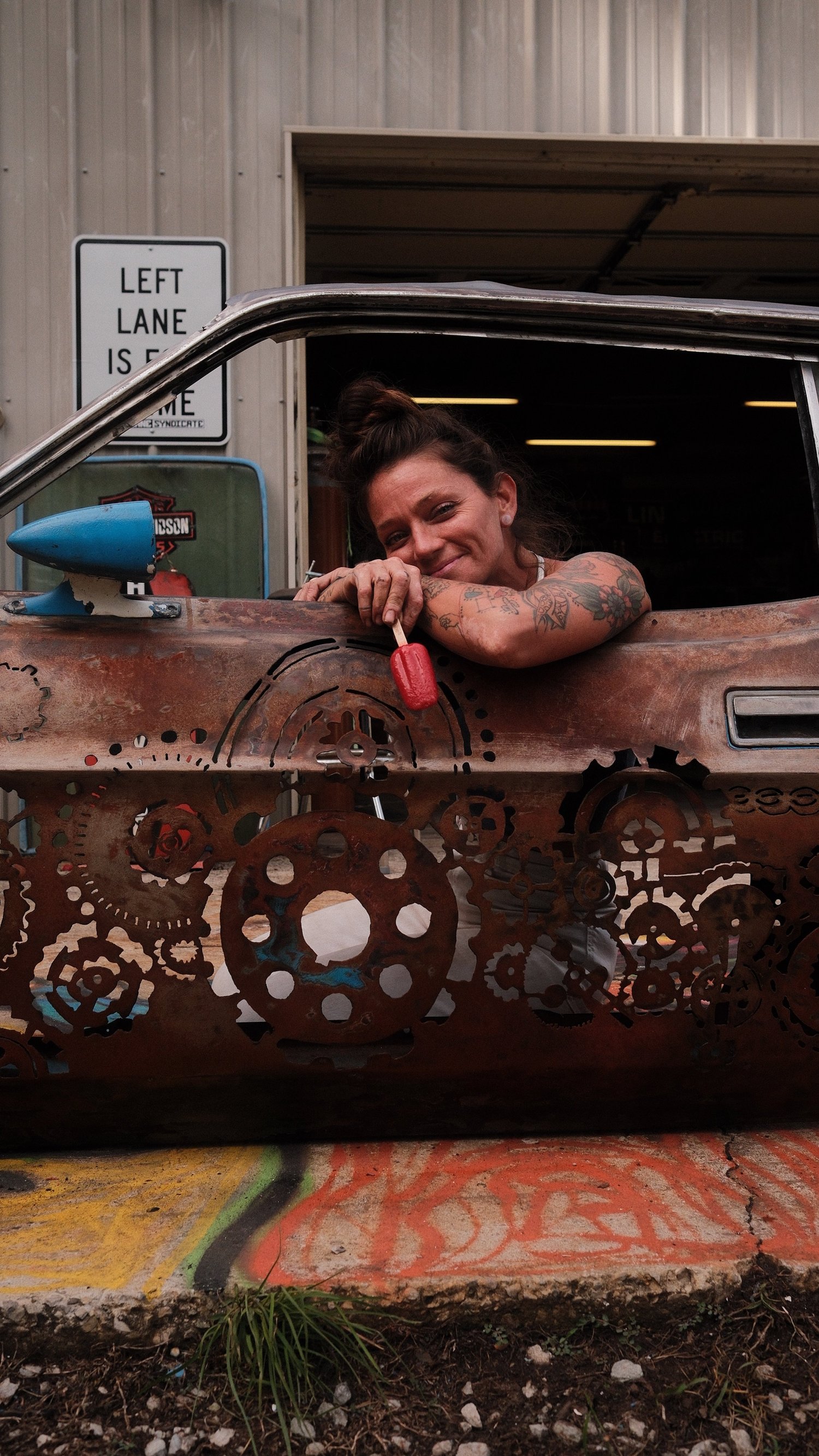 Rae Ripple smiling from a metal art car