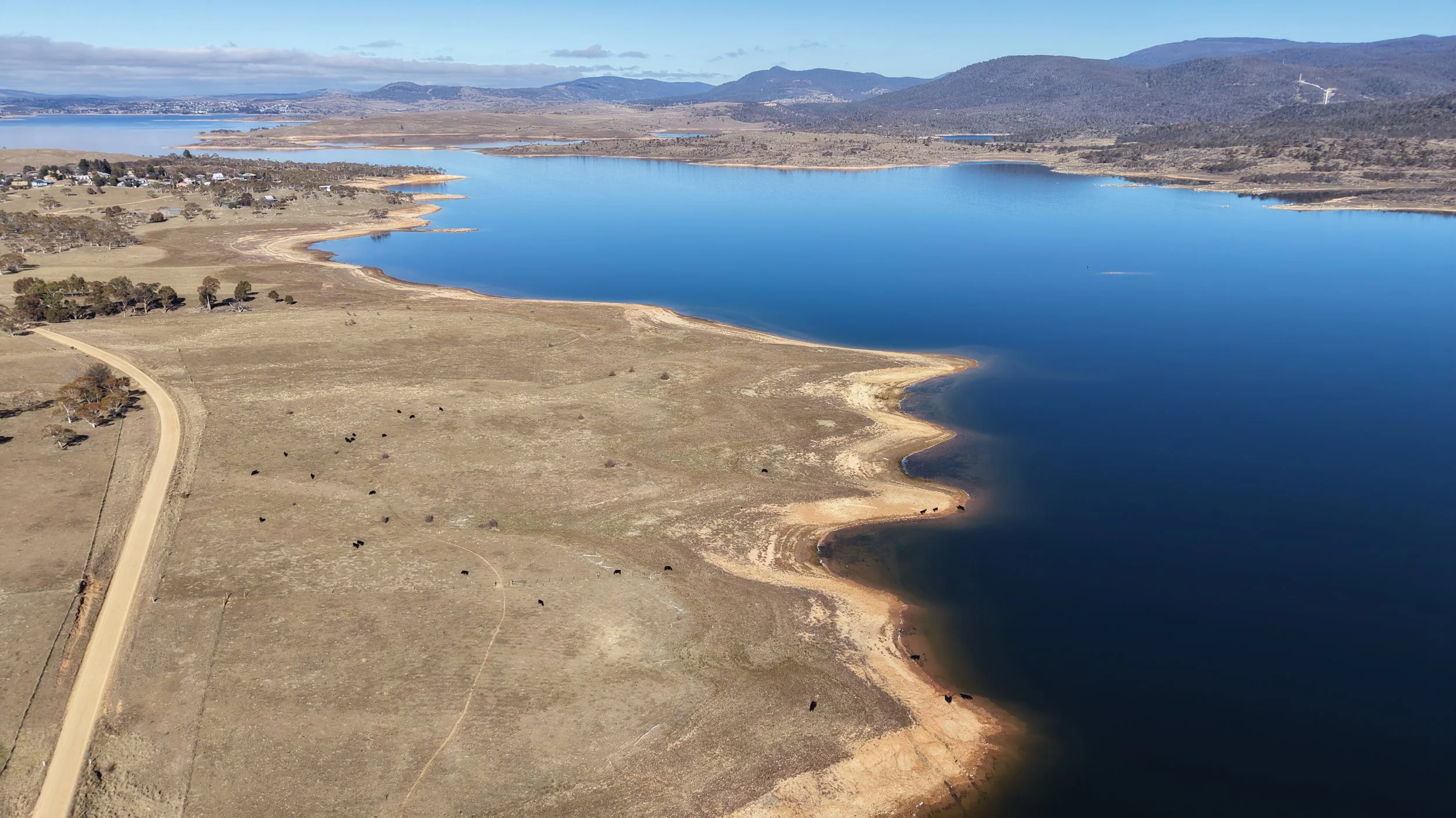 The Eastern Shore of Lake Jindabyne looking south towards the town of Jindabyne in the far distance. Visible is the town of Kalkite