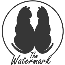 Silhouette of two cats sitting back to back inside a circular border with the text 'The Watermark' underneath.