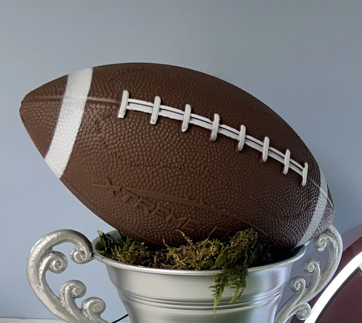 Football placed on top of spray painted urn for DIY Football Trophy décor | Sapient Spaces Franklin TN.