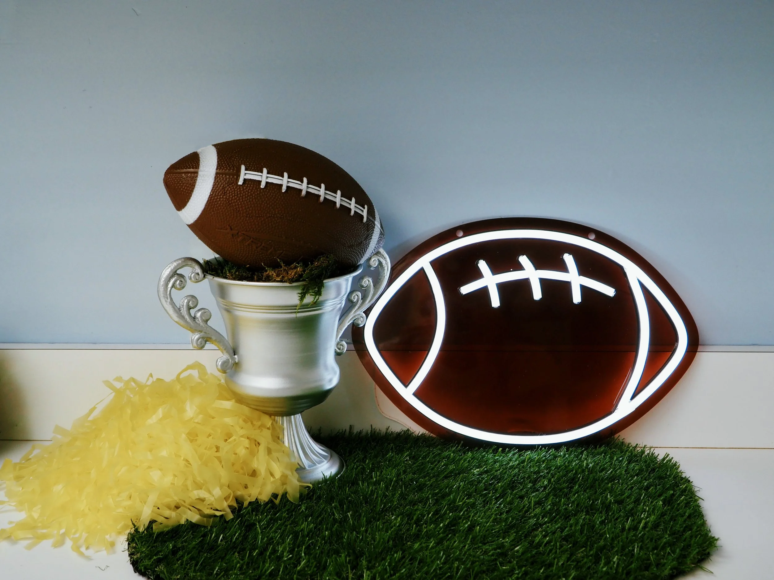 DIY Football Trophy décor with football and neon sign | Sapient Spaces Franklin TN