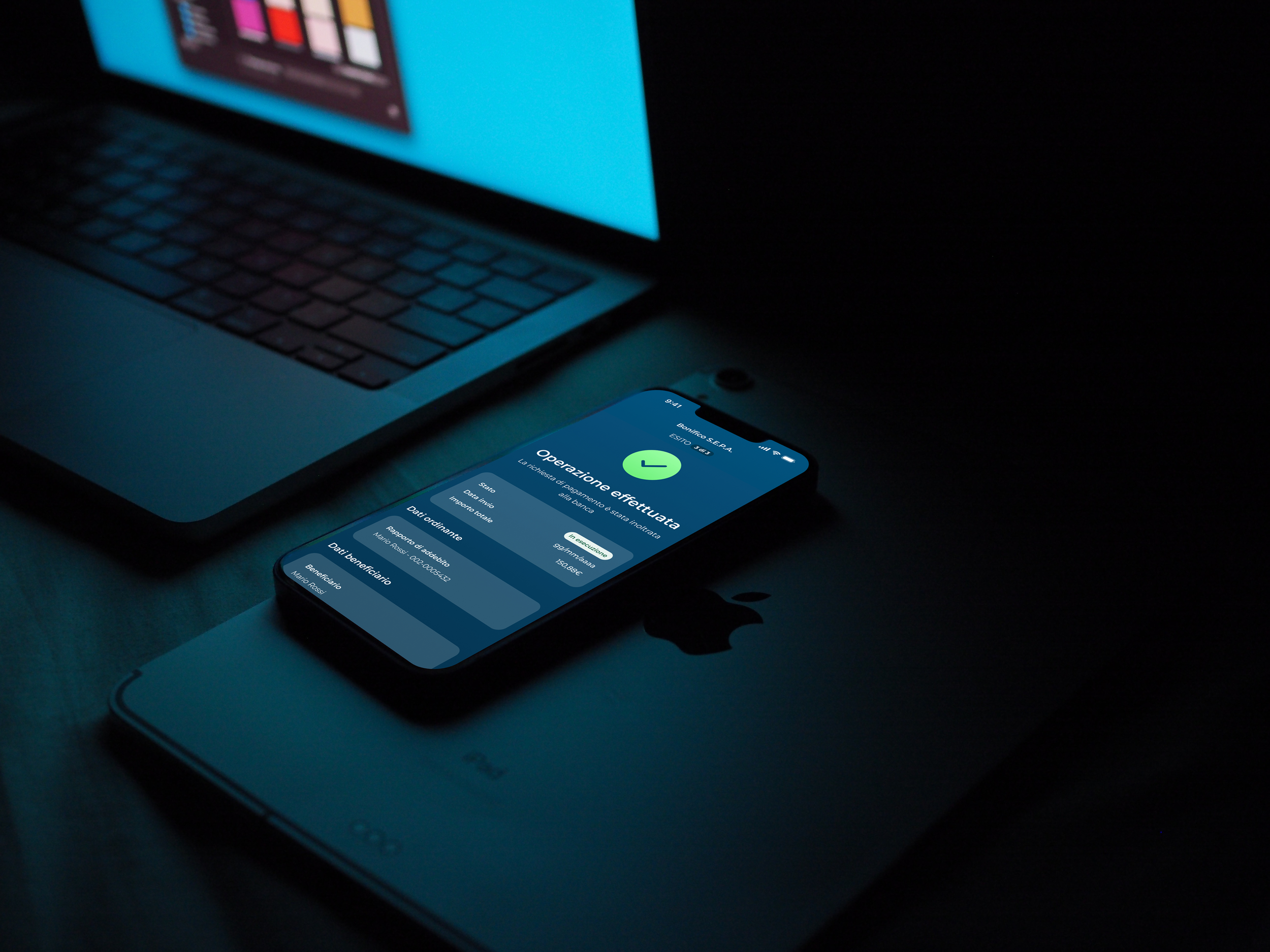 A smartphone displaying a successful operation confirmation screen, placed on a closed laptop with a visible Apple logo.