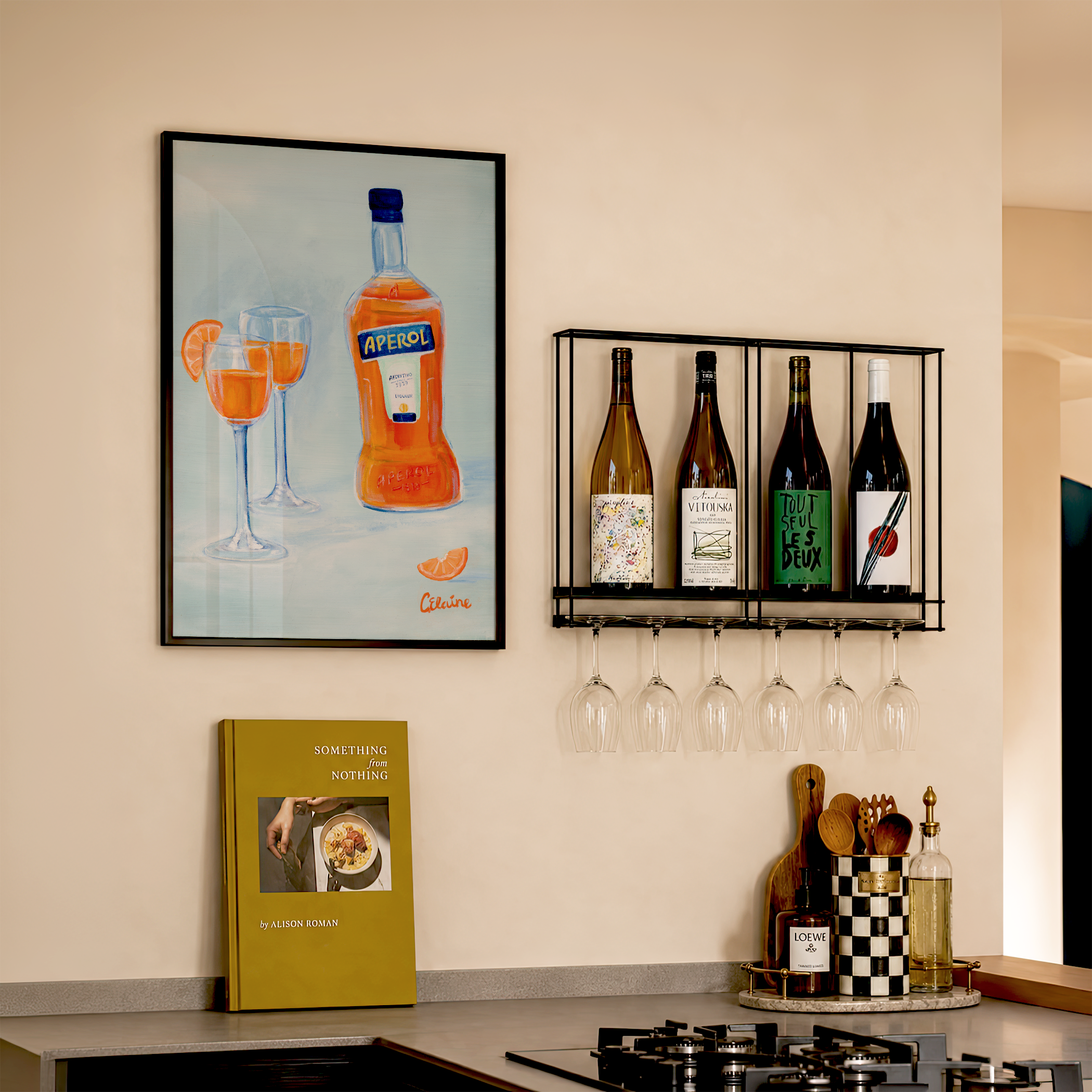 framed aperol spritz blue and orange painted artwork hanging in the kitchen by the bar cart