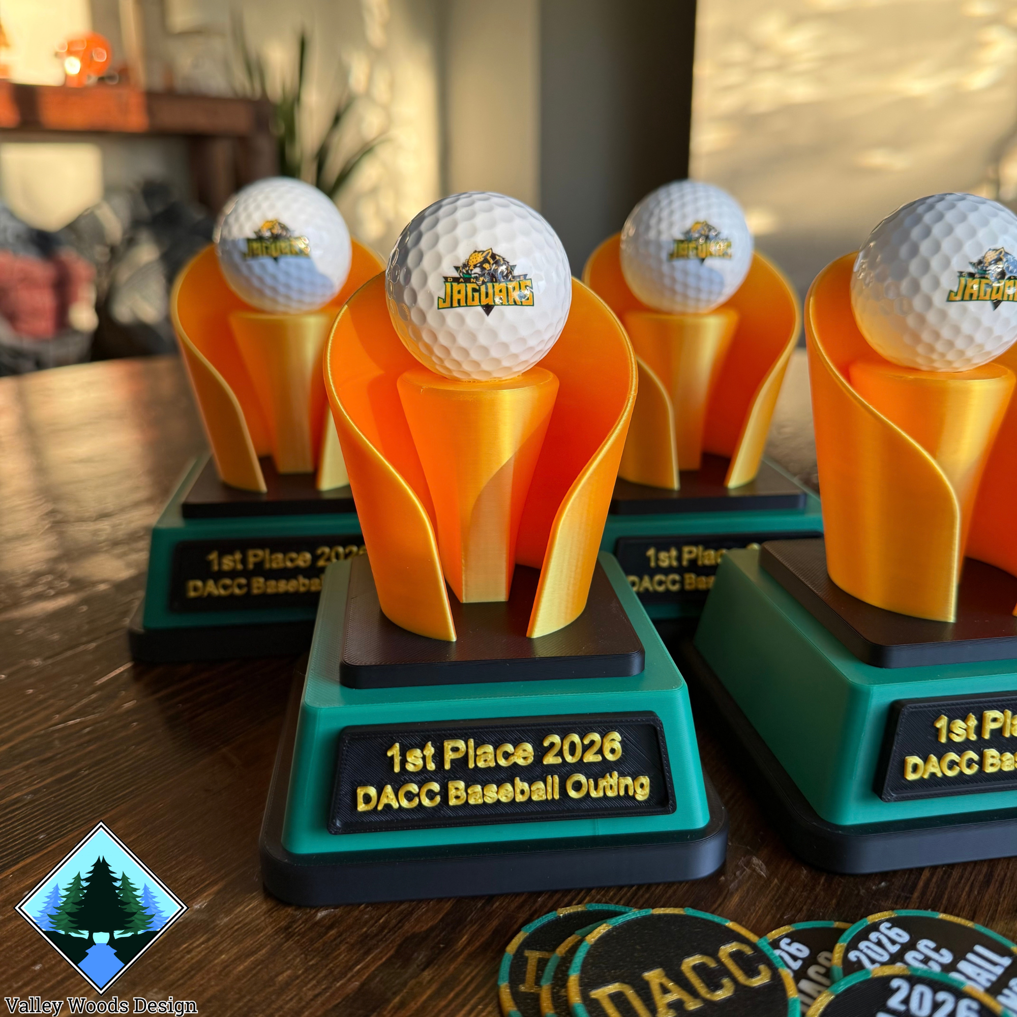 Green and gold DACC Baseball golf trophies featuring Jaguars logo golf balls