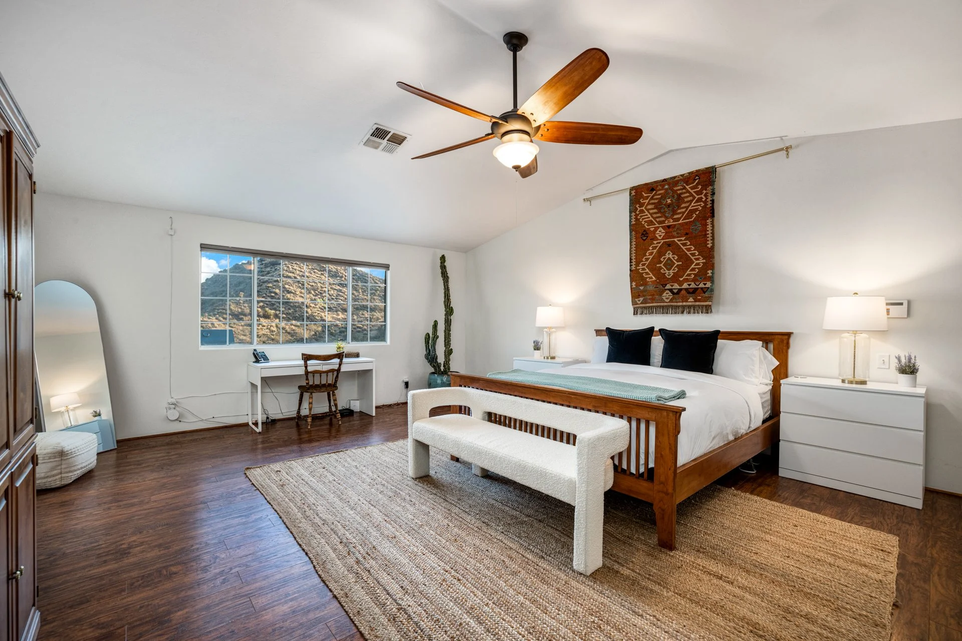 Very spacious bedroom with a desk.