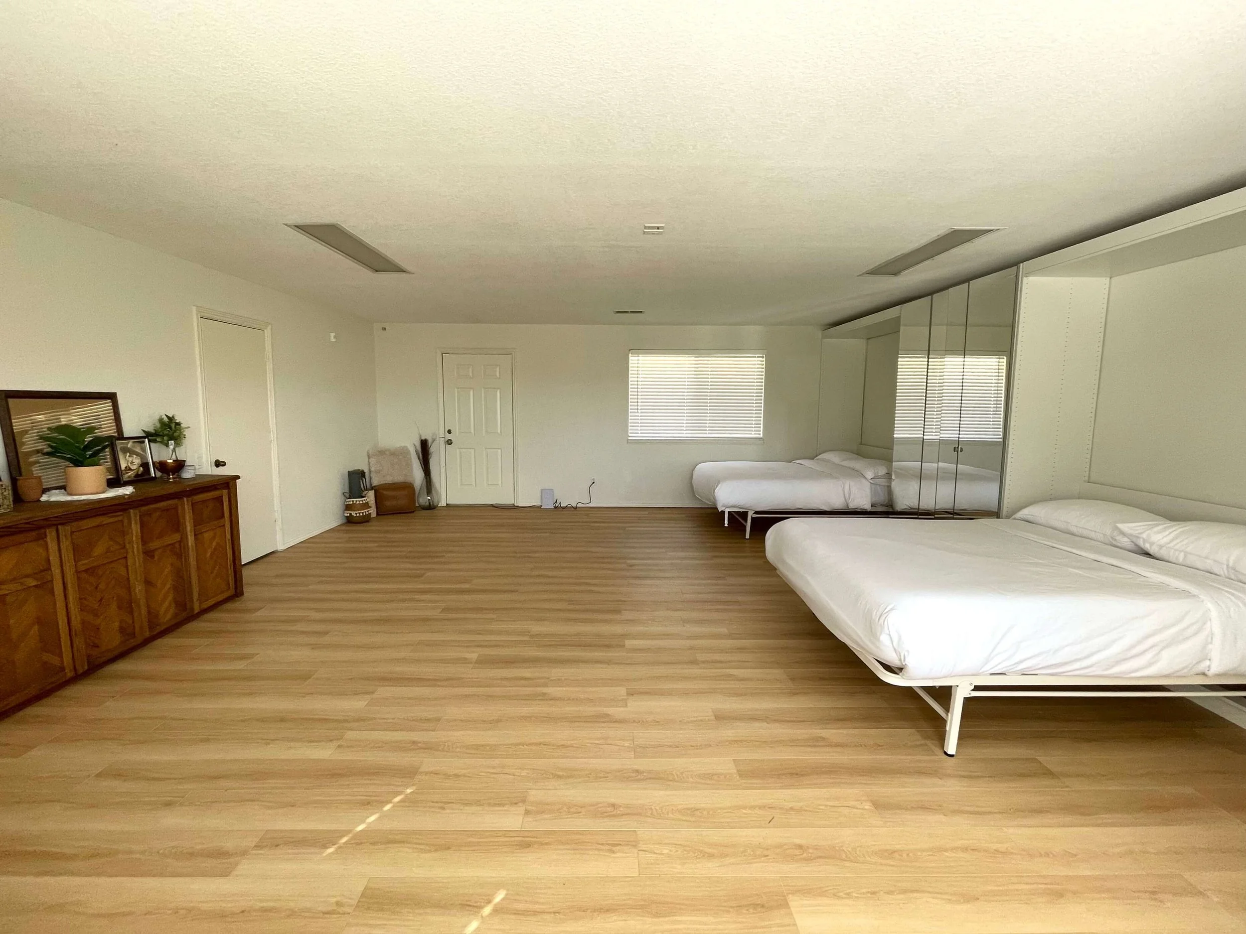 Two Queen sized Murphy beds, opened up in a large room.