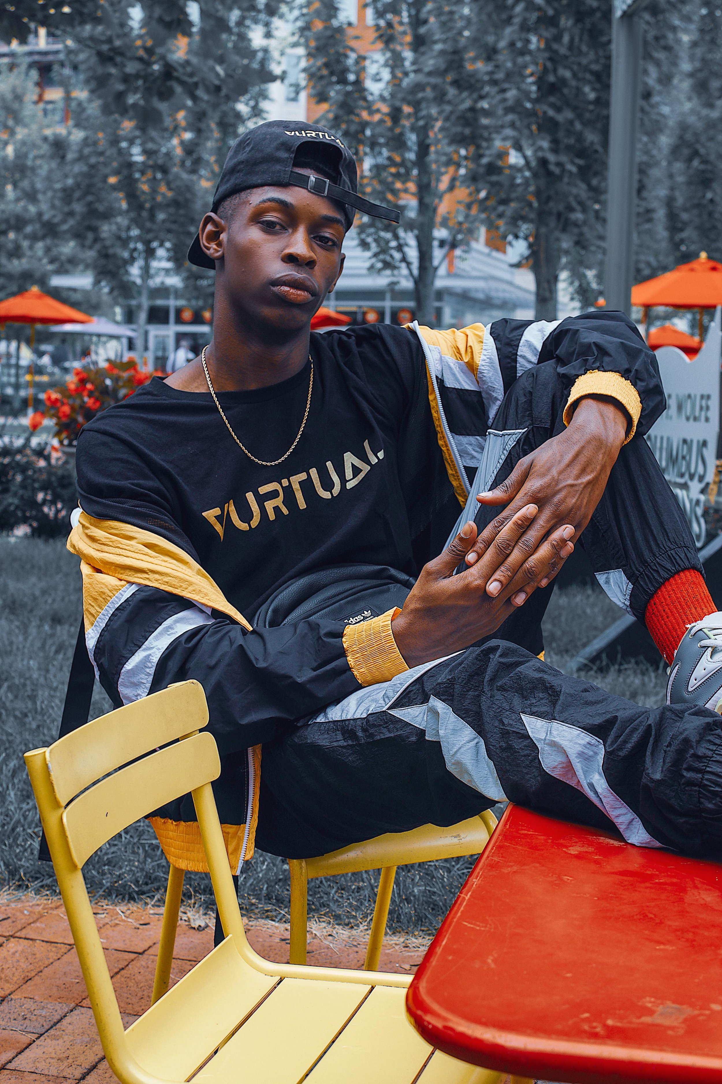 Man posing outdoors in yellow-accented Vurtual tracksuit