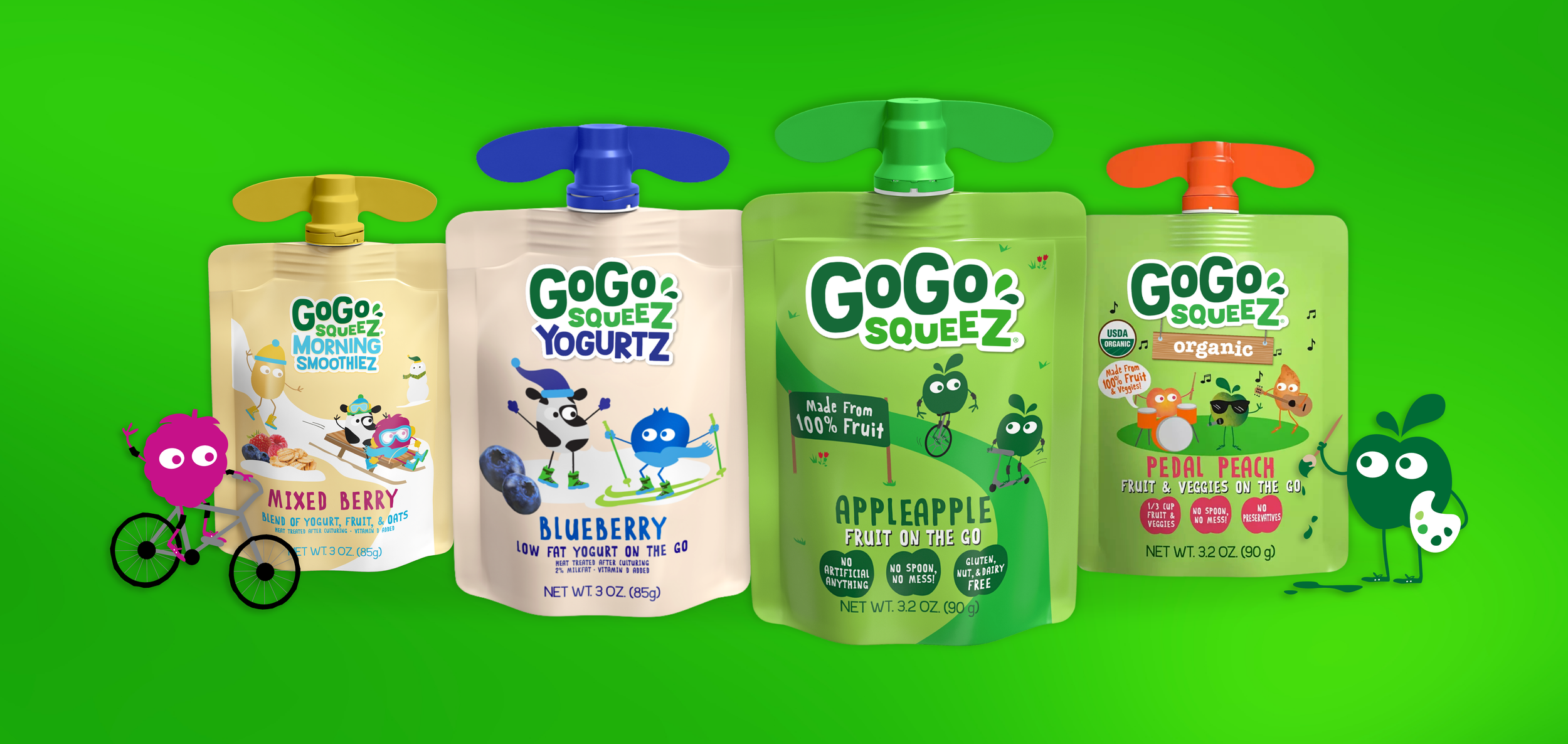 Four colorful squeezable fruit and veggie pouches with cartoon characters on a green background.