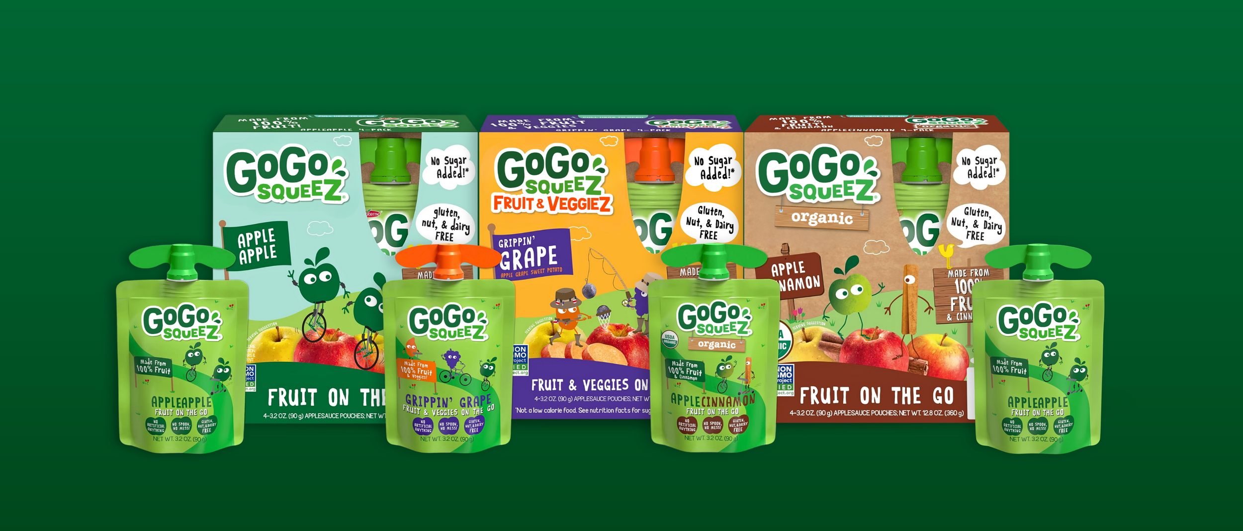 Lineup of various GoGo squeeZ fruit pouches and boxes with playful packaging, featuring apple, grape, cinnamon apple, and apple apple flavors, set against a green background.