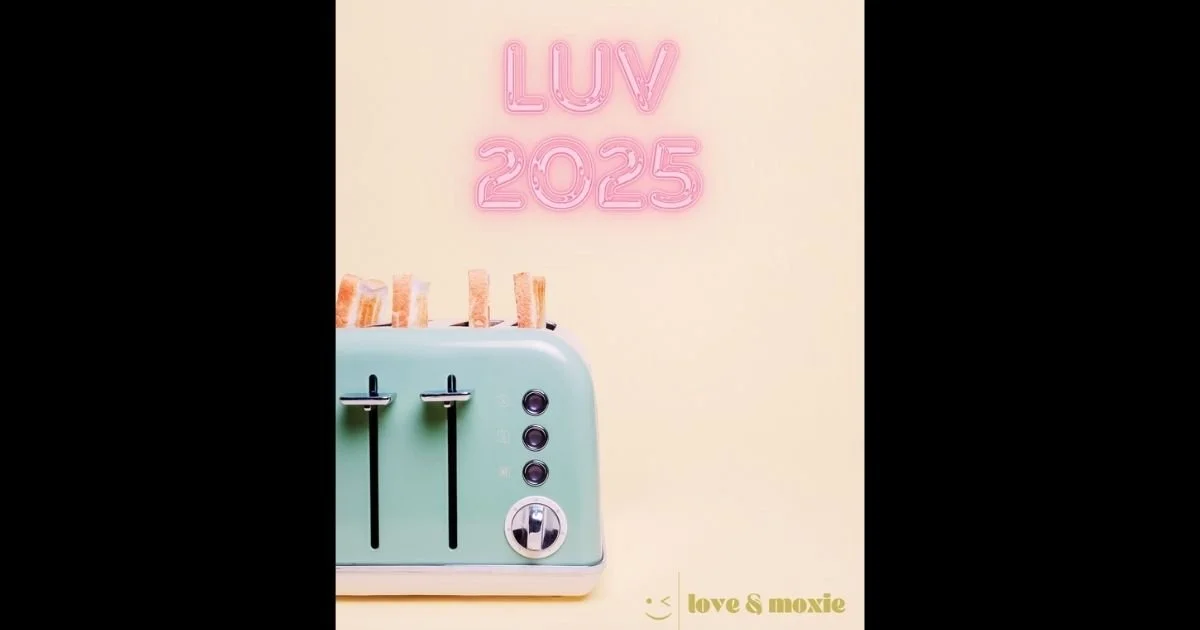A pastel green toaster with four slices of bread popping out and four black levers, set against a beige background with a pink neon sign reading "LUV 2025" at the top and the words "love & moxie" in gold at the bottom.