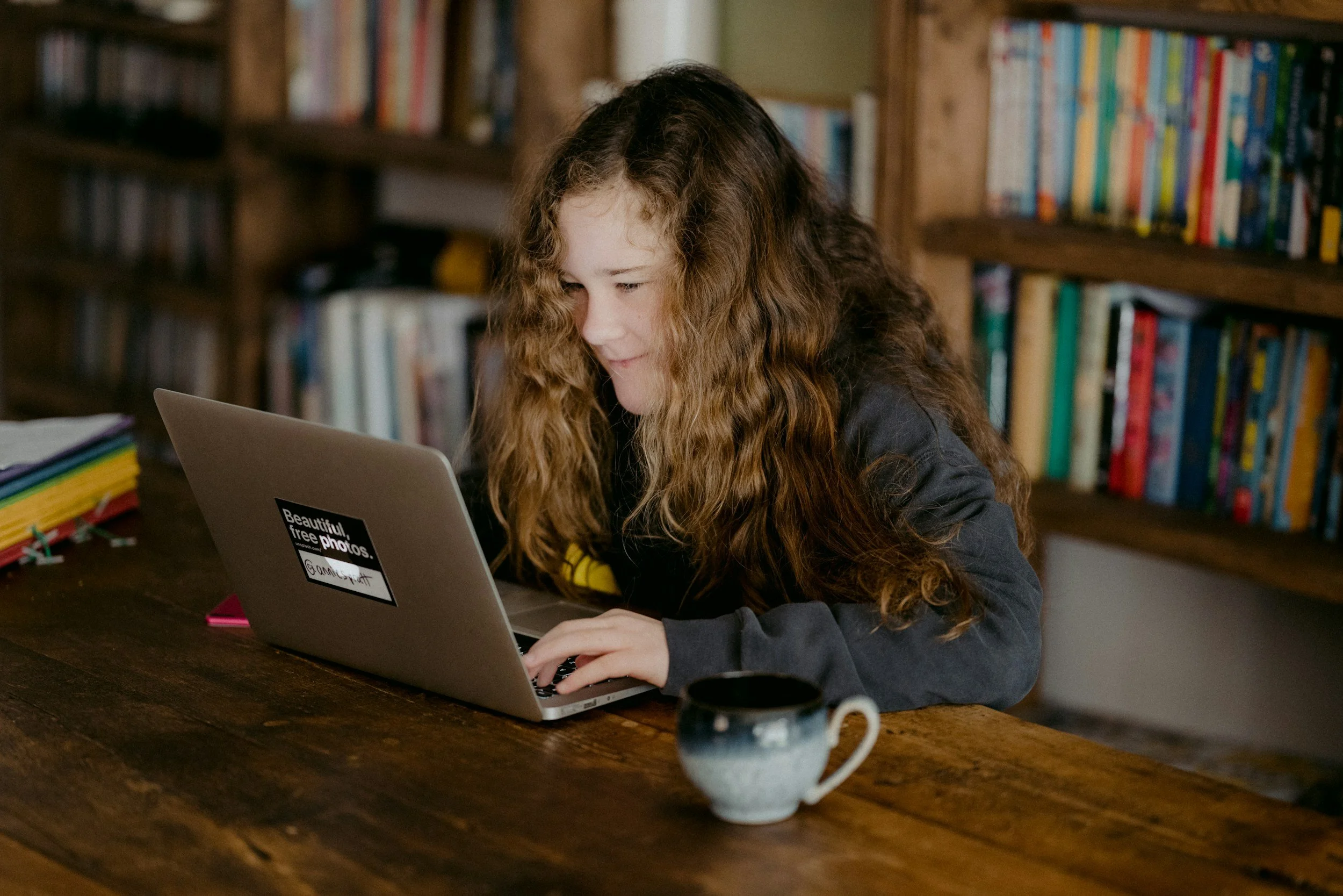 Teen girl in a library on a computer