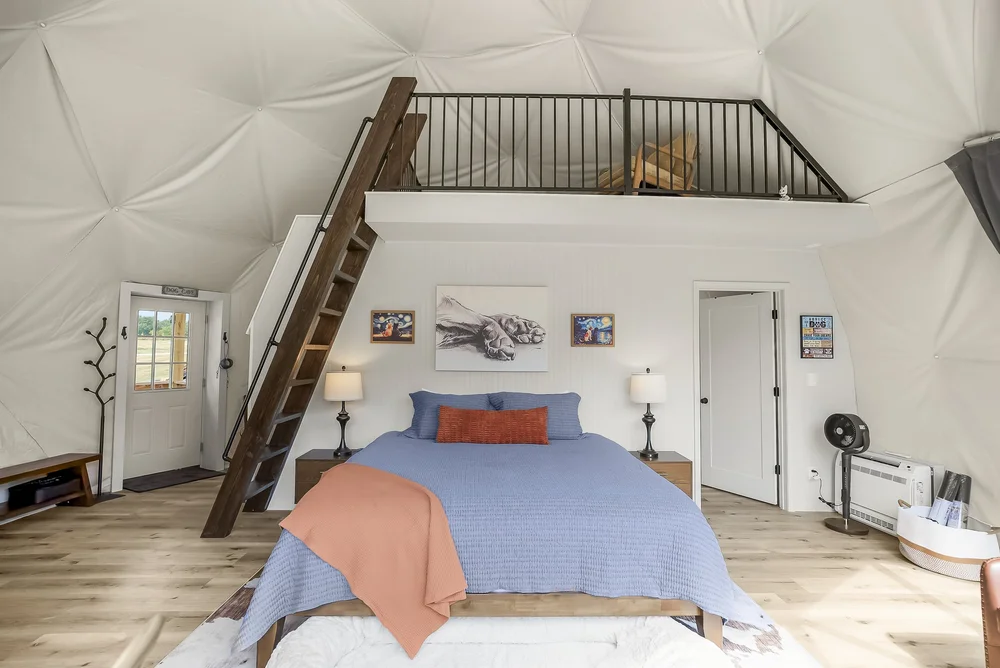 King bed and loft sleeping area inside The Fur Seasons dome