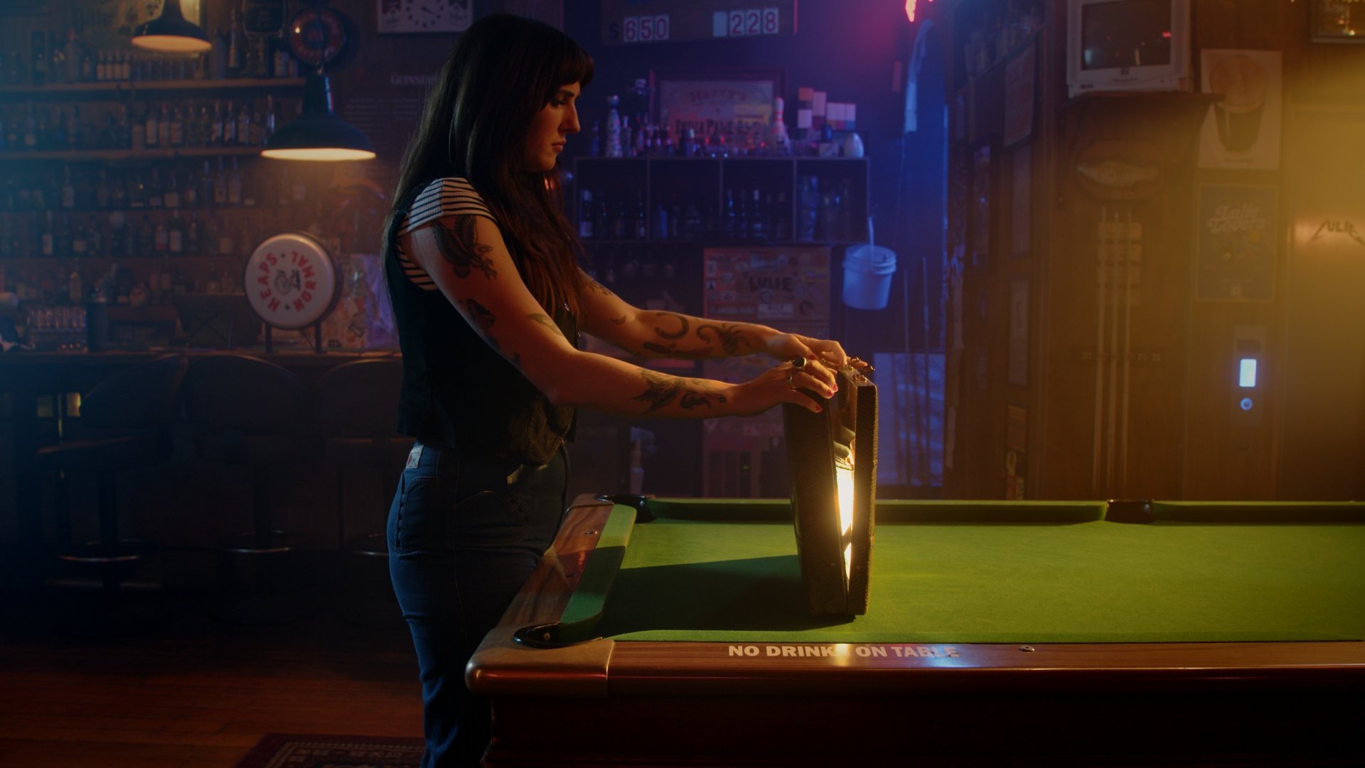 An image from a commercial brand video of a bartender opening a briefcase to find a golden ticket for the LuliePalooza music festival.