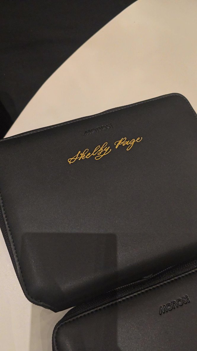 A black case with the words "Shelby Page" written in gold calligraphy.