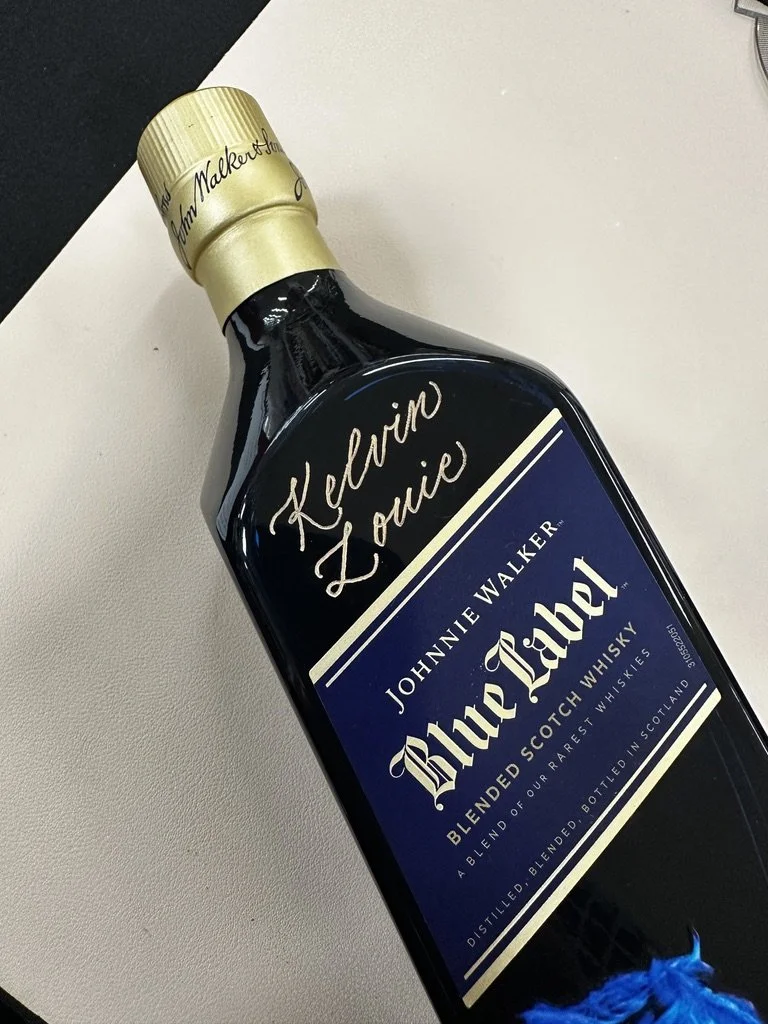 A bottle of Johnnie Walker Blue Label blended Scotch whisky lying on a white surface.