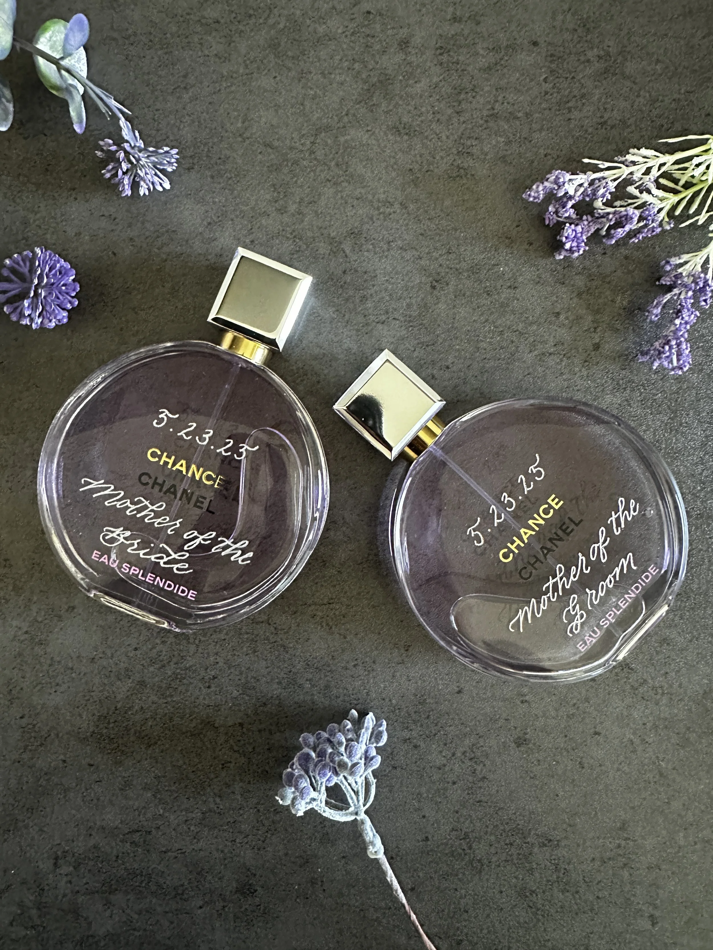 This is a picture to two engraved purple Chanel bottles.