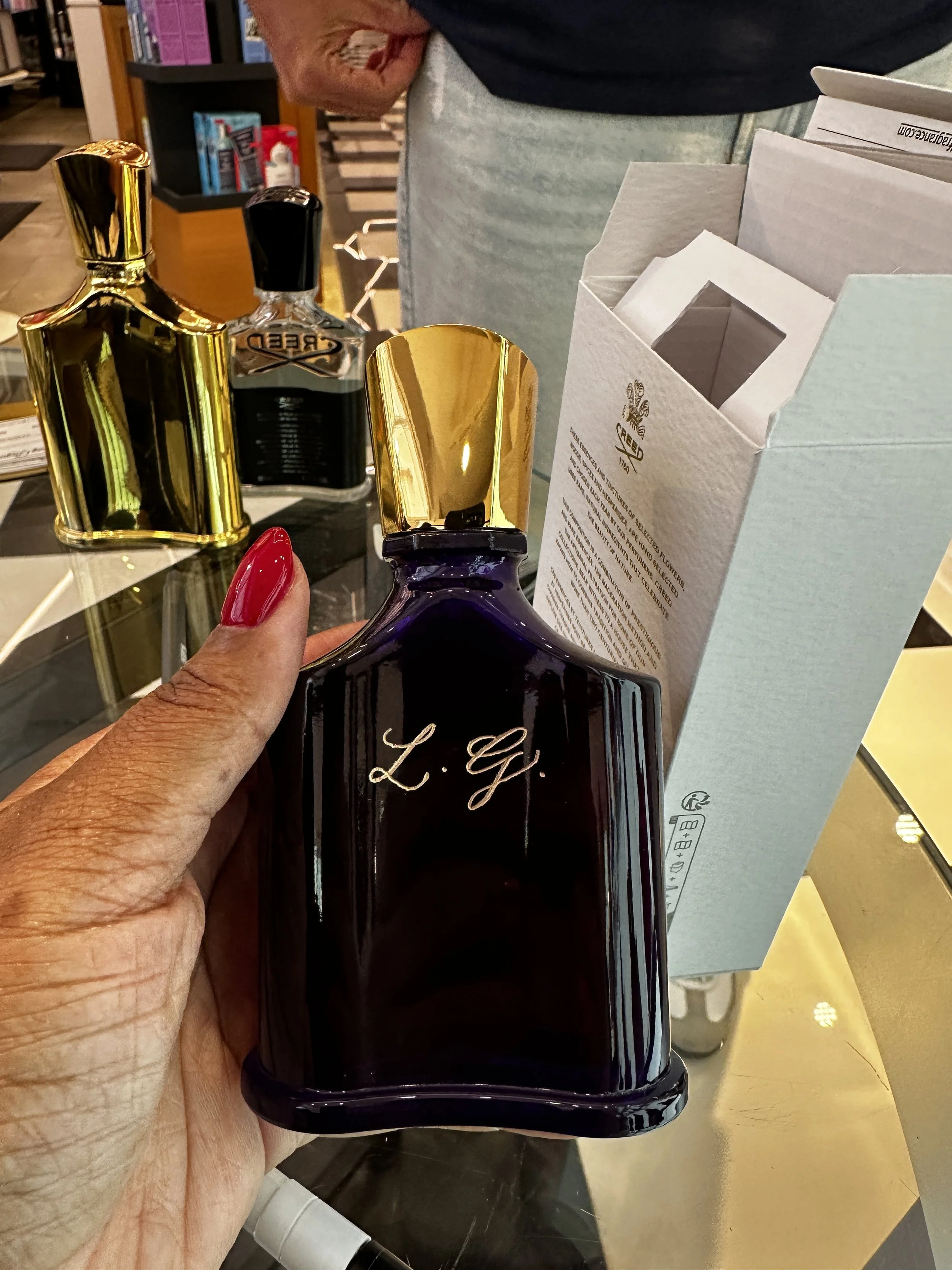 Creed engraved perfume bottle.