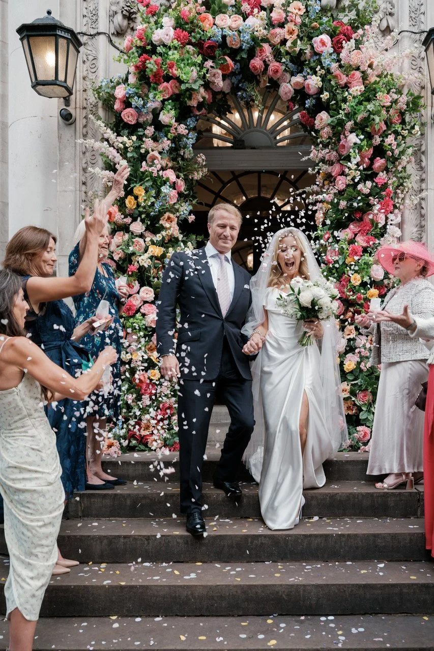 Newly married couple exit London townhall with confetti