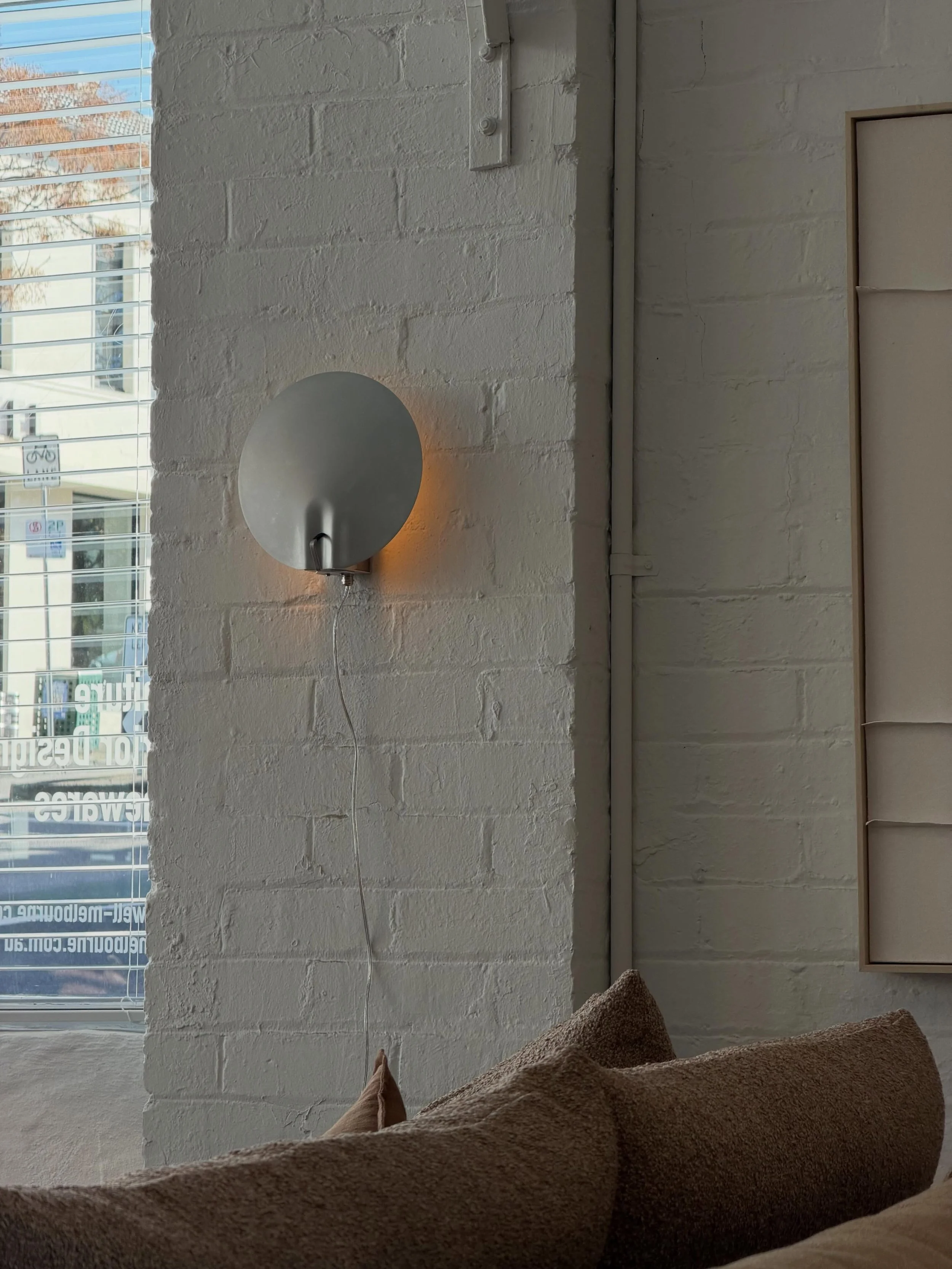 Its distinctive shade is created from a single pressed piece of aluminium, giving the light its sculptural shape and character.

Flect by Zowa.