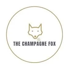 Logo of a fox face with the text 'The Champagne Fox' underneath, all within a circular border.