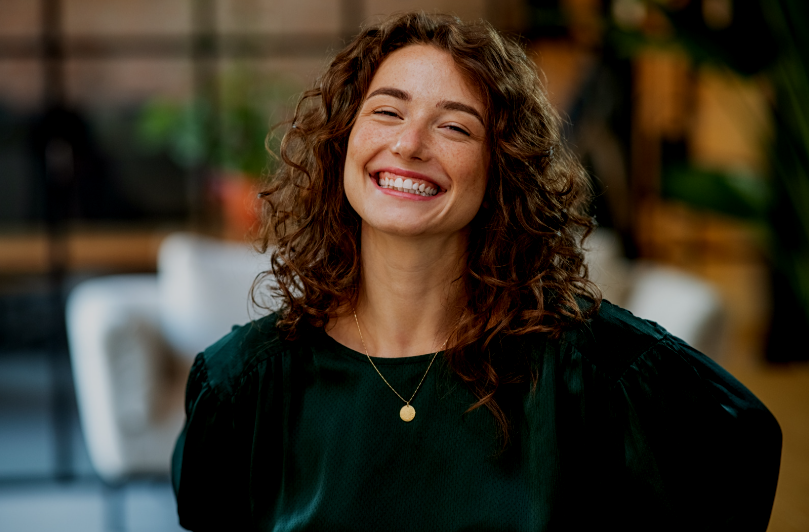 Smiling mother and two children using a laptop together on the sofa – reflecting timely, trusted ADHD and autism diagnosis for families.