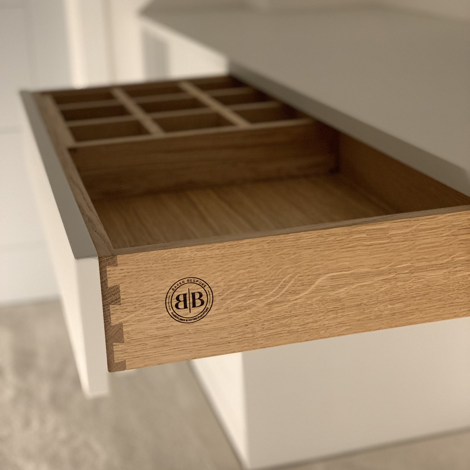 Open wooden drawer with organizer compartments, featuring a logo on the side.