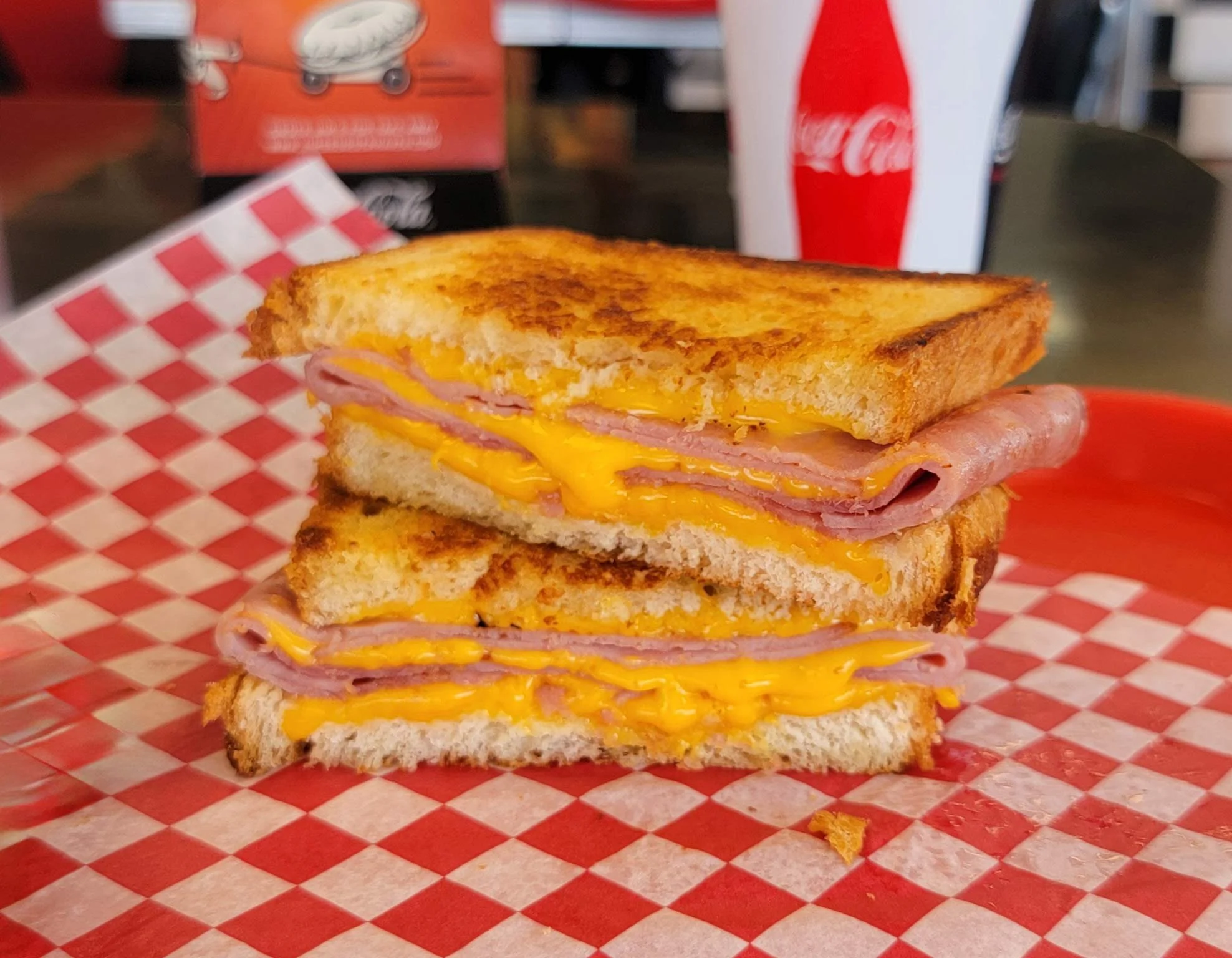 Old School grilled cheese sandwich with ham cut in half.