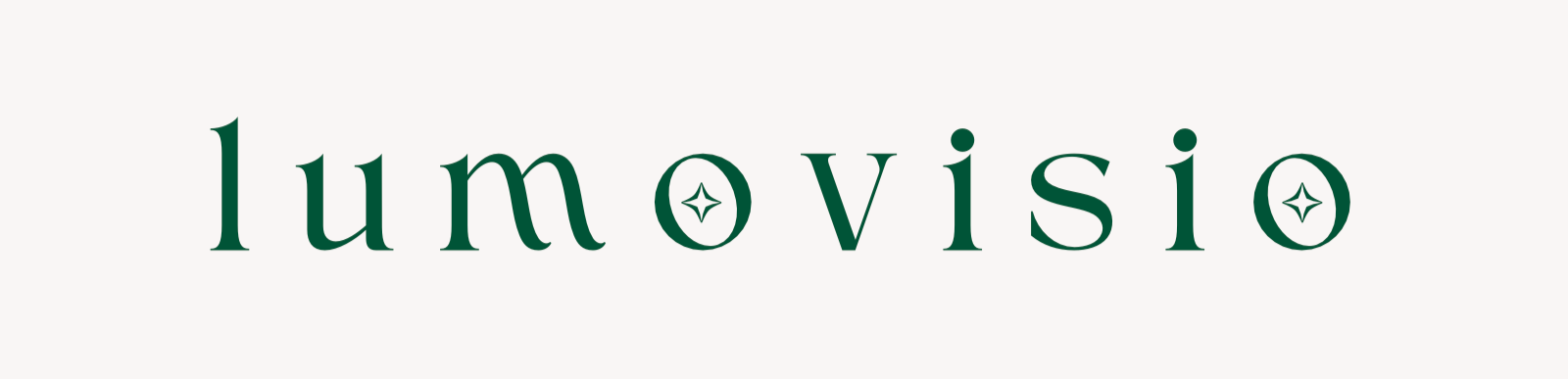 Valkoinen tausta, jossa on teksti 'lumovisio' vihreällä fontilla, sisällä pienet tähdet.